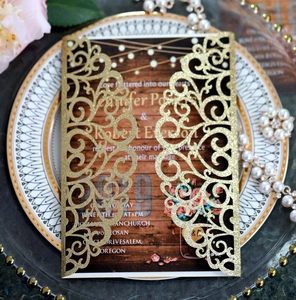 Detail of laser-cut gold glitter wedding invitation on elegant decorative plate