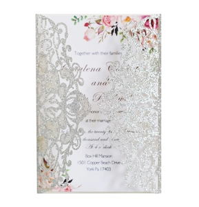 Close-up of silver glitter hollow wedding invitation with floral inner card details