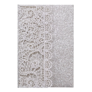 Detailed laser-cut silver glitter wedding invitation with elegant lace floral patterns