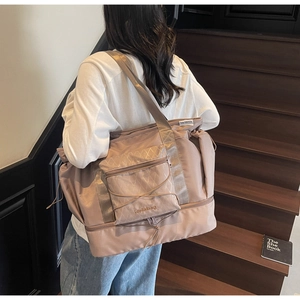 Detail view of pink waterproof travel bag with bottom shoe compartment and drawstring pocket