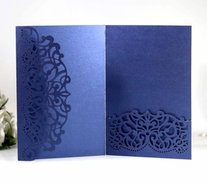 Detailed laser-cut dark blue lace invitation cover with elegant pearlescent finish