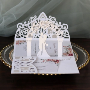 Elegant 3D laser cut wedding invitation card featuring bride and groom under a floral arch