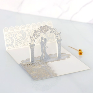 Detailed laser cut 3D wedding invitation featuring silver glitter silhouette of a couple