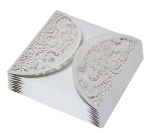 Detail of laser cut white lace floral wedding invitations in premium pearlescent paper