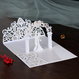 Detailed laser-cut 3D wedding card featuring a romantic couple silhouette under an arch