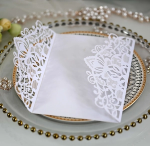 Detailed laser-cut white wedding invitation pocket with elegant floral lace texture
