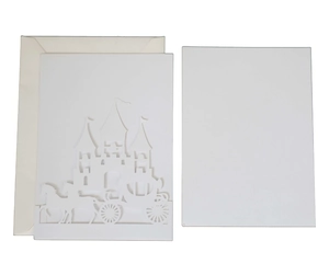 Close-up of laser-cut castle and carriage invitation with white envelope and insert