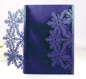 Détail de motifs de flocons découpés au laser sur papier violet pour cartes de fêtes