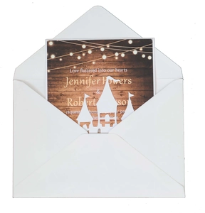 European laser-cut wedding invitation featuring a gold castle design and white envelope