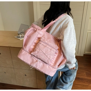 Pink waterproof travel bag showing functional side pocket and large storage capacity