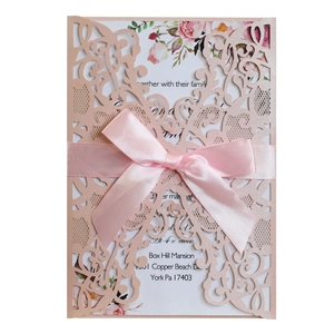 Pink laser-cut wedding invitation with elegant floral inner card and satin ribbon bow