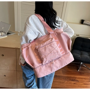 Detail of pink travel bag showing the bottom shoe compartment and large storage capacity