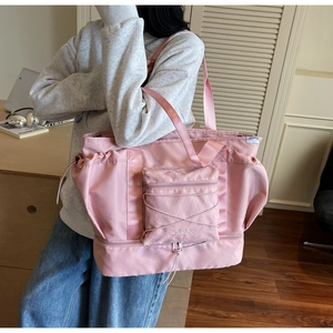 Detailed view of pink nylon travel tote with dry-wet separation and bottom shoe compartment