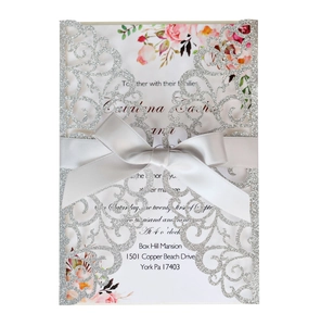 Laser cut silver glitter wedding invitation with grey satin bow and floral inner card