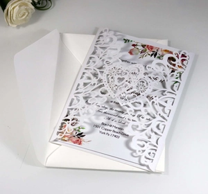Detailed laser cut white floral wedding invitation with inner card and envelope