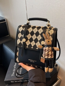 Checkered canvas and black leather backpack with a cute knitted bunny charm
