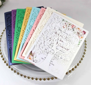 Detail of laser-cut wedding invitation featuring intricate floral and tree patterns
