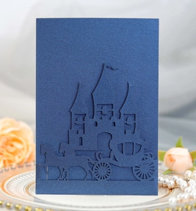 Detailed laser-cut dark blue wedding invitation featuring a castle and carriage motif