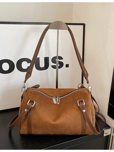Caramel brown matte suede pillow bag with dual metal zippers and sturdy top handles