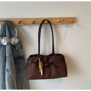 Deep brown faux suede tote bag with slim straps and vintage beaded charm detail