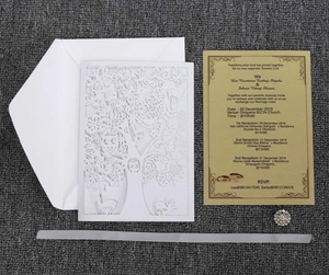 Detail of laser cut laser cut wedding invitation with tree design and gold insert card