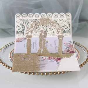 Detail of 3D pop-up wedding invitation with laser-cut gold glitter and floral design