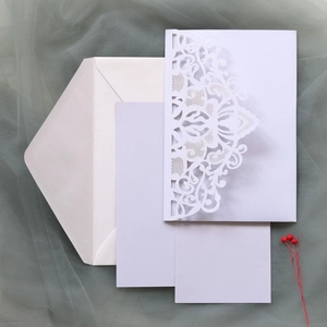 Macro detail of laser-cut wedding invitation with intricate damascus floral patterns