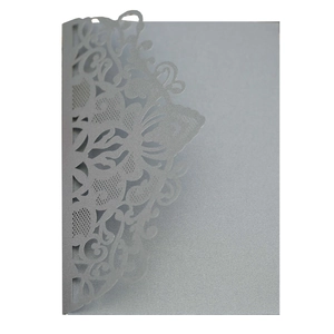 Detailed laser cut mandala pattern on silver pearlescent wedding invitation cover