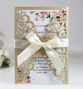 Elegant gold laser cut wedding invitation card with ribbon bow and floral design