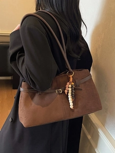 Deep brown faux suede shoulder bag with vintage beads, shown worn under the arm