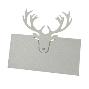 Close-up of laser-cut reindeer seat card in silver pearlescent paper for Christmas tables