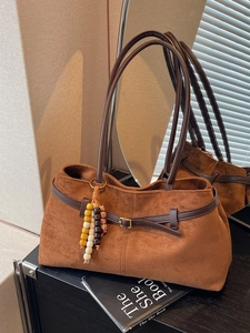 Vintage brown suede tote bag with leather straps and decorative beaded charm