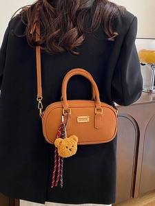 Classic brown leather bowling bag for women with cute bear charm and adjustable strap
