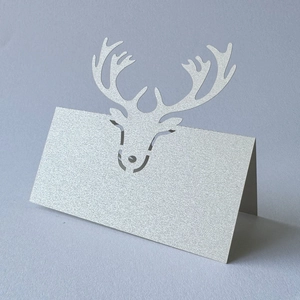 Detail of silver glitter laser-cut reindeer place card for Christmas table setting