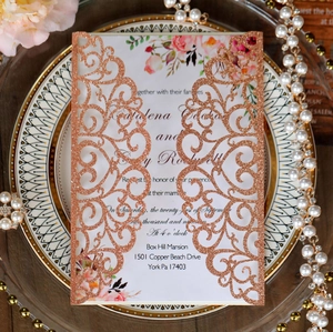 Detail view of rose gold laser-cut wedding invitation with elegant floral insert