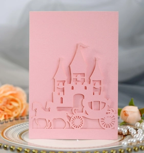 Intricate laser-cut details of a pink 3D greeting card with castle and carriage