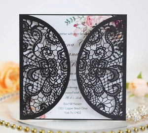 Detailed laser-cut black lace wedding invitation set with floral watercolor accents
