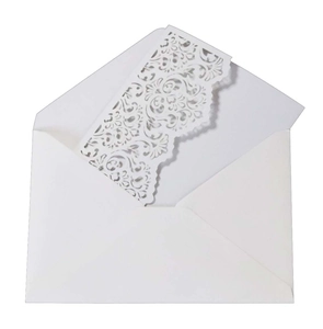 Detail showing the intricate laser-cut floral pattern and matching white paper envelope