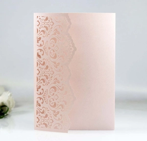 Detailed laser-cut floral pattern on elegant pearlescent pink invitation card