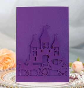 Detail of laser-cut purple invitation with elegant castle and carriage motifs