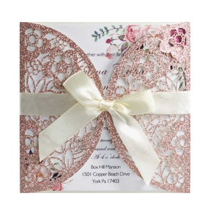 Rose gold laser cut floral wedding invitation with pink flower card and cream ribbon