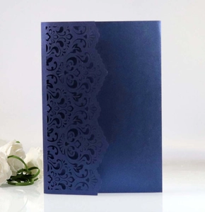 Detail of laser-cut floral pattern on navy blue pearlescent pocket wedding invitation card