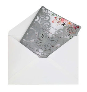 Detail of laser-cut silver lace cover with butterfly patterns and pink floral inner card