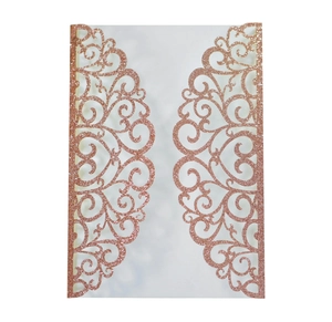 Detail of rose gold laser cut wedding invitation with glitter finish and floral heart patterns