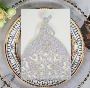 Macro view of silver glitter laser-cut invitation holder with intricate dress design