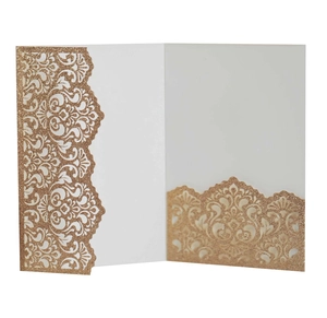 Detail of champagne gold glitter paper laser-cut invitation sleeve with baroque scrolls