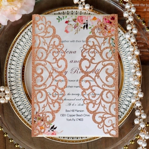 Detail of rose gold glitter laser-cut wedding invitation with elegant floral inner page