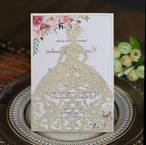 Macro detail of laser-cut glitter gold wedding invitation with elegant girl silhouette