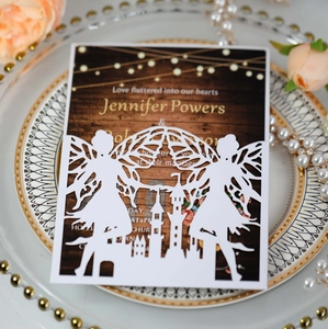 Detail of laser-cut fairy and castle invitation card on decorative ceramic plate