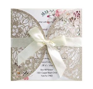 Champagne gold laser cut wedding invitation with glitter finish and satin bow decoration